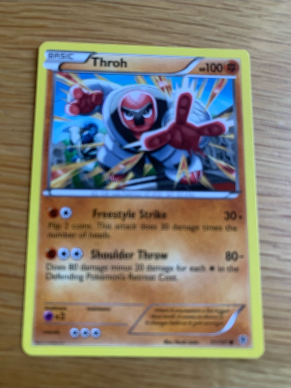 Pokemon Throh Card with Yellow Border and Orange Artwork